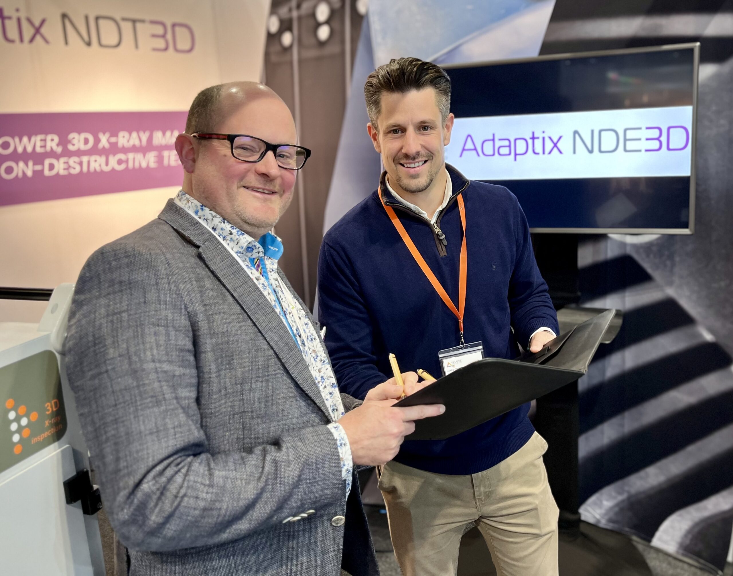 representatives from Adaptix and Sempre signing distribution agreement